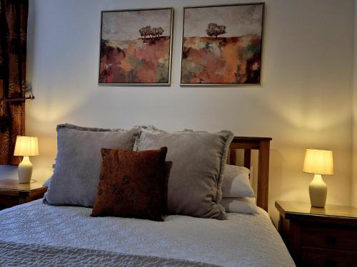 a bedroom with a bed with three pictures on the wall at The Badger Inn in Church Minshull