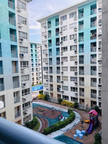 an apartment with a pool and a playground at Seawind Condominium in Davao City