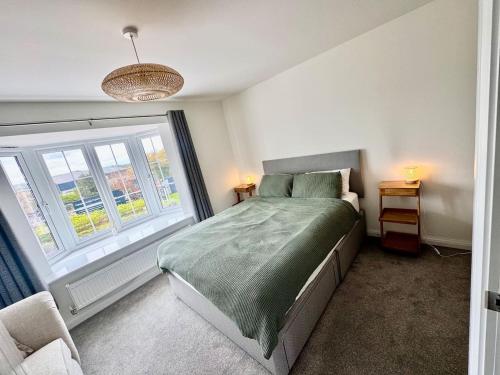 a bedroom with a bed and a large window at Upper Townhouse, Exeter in Alphington