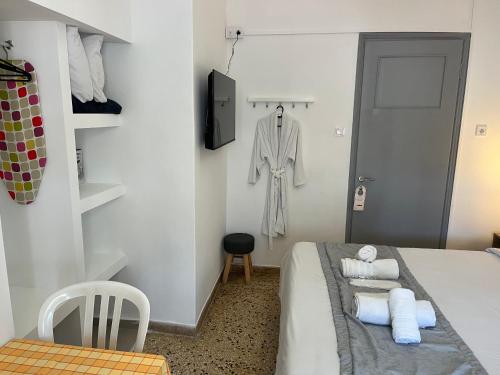 a bedroom with a bed with towels on it at Sunset view Rooms in Agia Triada