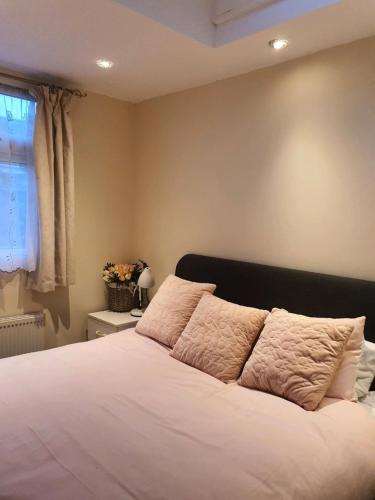 a bedroom with a bed with white sheets and a window at Animal friendly Sea 2 mins away in Trusthorpe