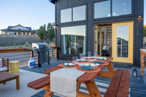 a wooden table on a deck with a grill at Stargazing Retreat with Hot Tub Deck Hammocks BBQ in Glendale