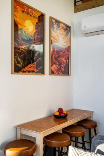 a table in a room with two posters on the wall at Stargazing Retreat with Hot Tub Deck Hammocks BBQ in Glendale
