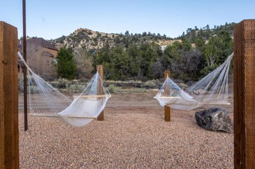 a group of hammocks sitting on the ground at Stargazing Retreat with Hot Tub Deck Hammocks BBQ in Glendale