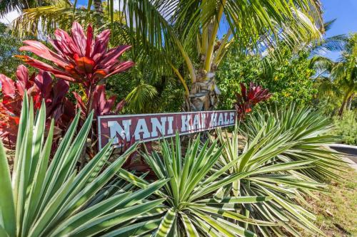 a street sign in front of some plants at Beachfront Condo in Kihei in Kihei