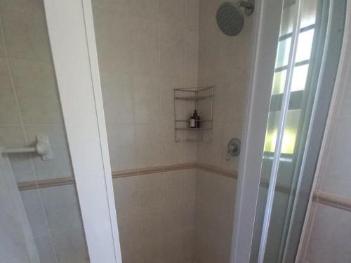 a bathroom with a shower with a glass door at Waves of Mercy in Trafalgar