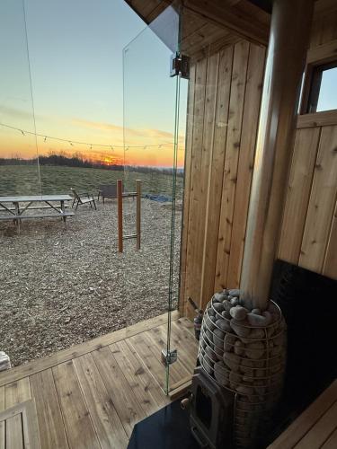a room with a fireplace and a view of a beach at The Retreat on the Ranch (INSANE VIEW) in Gap