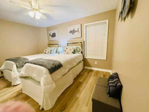a bedroom with two beds and a ceiling fan at Eastgate 10A beautiful townhouse in Hammond