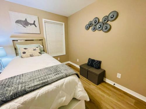 a bedroom with a bed and a clock on the wall at Eastgate 10A beautiful townhouse in Hammond