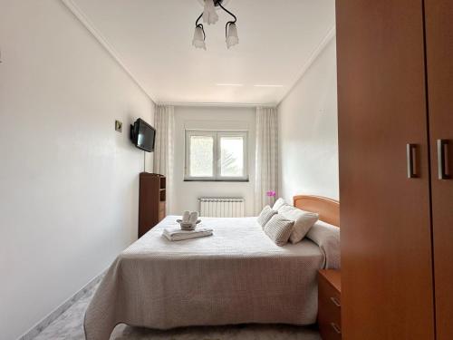 a bedroom with a bed in a white room at La Cava en Isla - 5611 in Isla