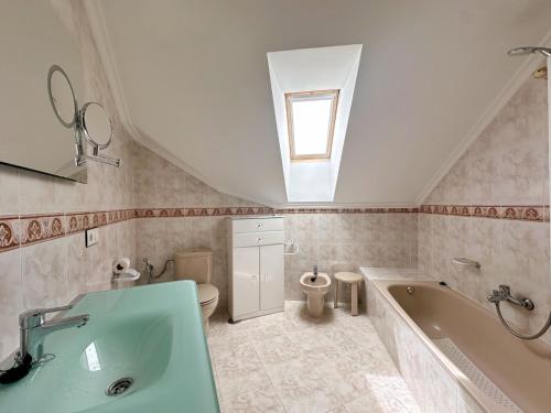 a bathroom with a sink and a tub and a toilet at La Cava en Isla - 5611 in Isla