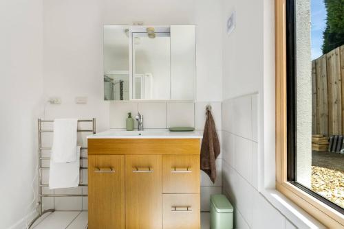 a bathroom with a sink and a mirror at Stylish Studio with Stunning Views in Lindisfarne