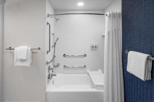 a white bathroom with a tub and a shower at Fairfield Inn by Marriott Santa Clarita Valencia in Santa Clarita