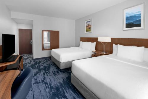a hotel room with two beds and a flat screen tv at Fairfield Inn by Marriott Santa Clarita Valencia in Santa Clarita