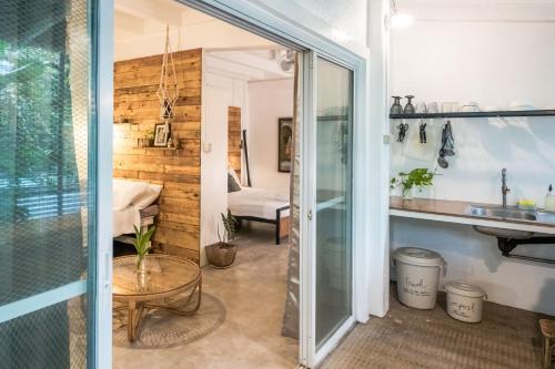 a bathroom with a sliding glass door leading into a room at PITI Nest Self-Service Home in Rainforest Nest - Wi-fi, Monkeys, Bats, Pet Friendly with a Fee in Subic Bay Intl