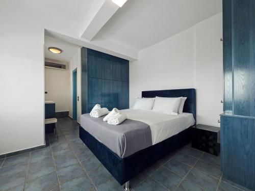 a bedroom with a large bed with towels on it at Sea View Residence Panorama Villa in Saronida
