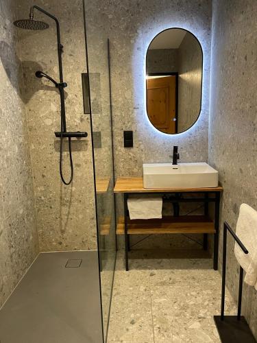 a bathroom with a sink and a mirror at Springhouse in Bad Gastein