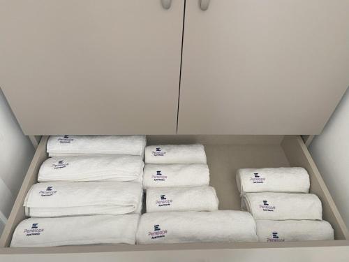 a bunch of towels are stacked in a closet at Penelope Apartments 15 in Xlendi