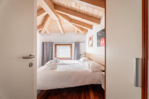 a bedroom with a bed and a wooden ceiling at Piccola Corte in Arco
