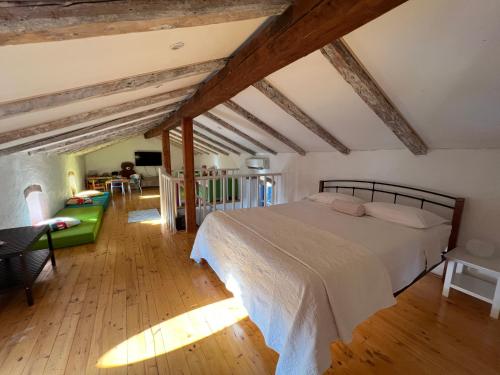 a bedroom with a bed in a room with wooden floors at Villa Rafaela Umag in Umag