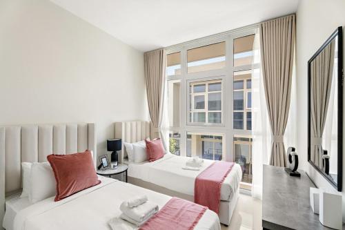 a hotel room with two beds and a window at Tranquil 3BR Villa with Malibu Beach Access in Dubai