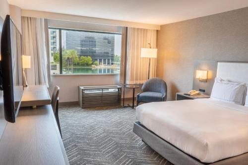 a hotel room with a bed and a large window at Orange County Hotel in Santa Ana