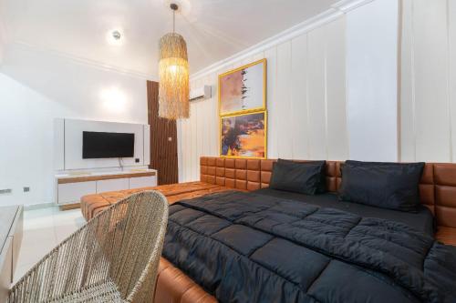 a living room with a couch and a television at Tastefully furnished two bedrooms lekki lagos in Lekki