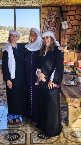 a group of three women dressed in black and white at Dana bedouin Sky in Dana