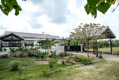 a house with a garden in front of it at Villa RNB 2BR Medan in Sunggal