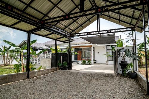 an external view of a house with a metal roof at Villa RNB 2BR Medan in Sunggal