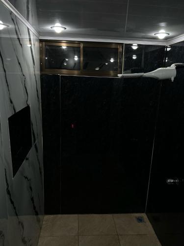 a bathroom with a shower with a glass door at Residencia Esmeralda in Agua Buena