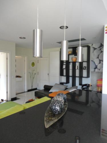 a living room with a couch and a table at Apartamento Raio de Sol in Caniço