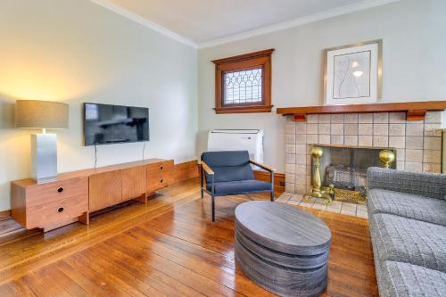 a living room with a couch and a fireplace at Walkable Apt 4 Mi to Downtown Toledo! in Toledo