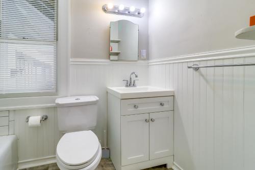 a white bathroom with a toilet and a sink at Walkable Apt 4 Mi to Downtown Toledo! in Toledo