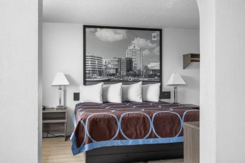 a hotel room with a bed with a picture on the wall at Casa Del Mar Hotel in Norfolk