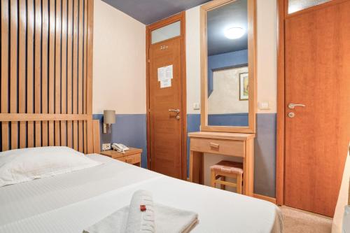 a bedroom with a bed and a wooden door at Hotel Rendez Vous in Kotor