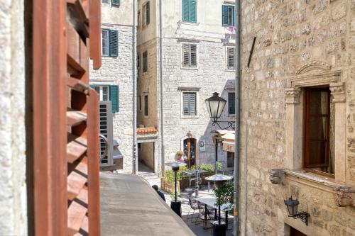 an alley in an old city with a building at Hotel Rendez Vous in Kotor