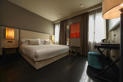 a hotel room with a bed and a desk at U-Visionary Venezia Hotel in Venice