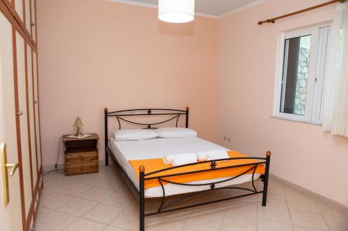 a bedroom with a bed and a window at Ionian Sea in Nikiana
