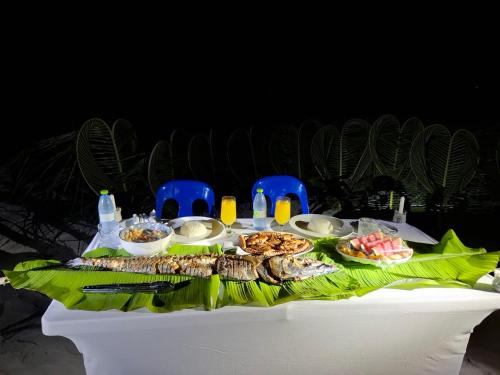 a white table with food on top of it at Dhontakuru Guest House in Ariyaddu