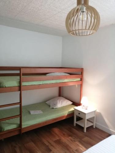 Cette chambre comprend 3 lits superposés et une lampe. dans l'établissement La tidette, à La Celle-sous-Gouzon