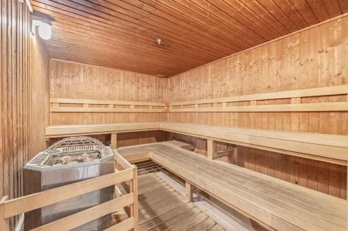 an empty sauna with wooden walls and wooden benches at Studio with Partial Ocean View & Balcony Unit 1901 in Honolulu