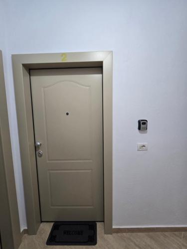 a door in a room with a scale next to it at Prima Apartments in Pogradec