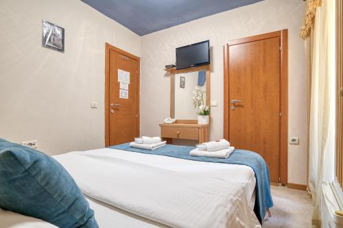 a bedroom with a bed with two towels on it at Hotel Rendez Vous in Kotor