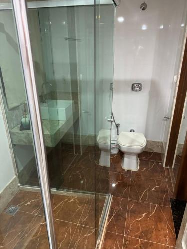 a bathroom with a shower and a toilet at Casa em Guarapari in Guarapari