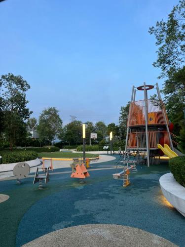 a park with a playground with a slide at Mus Lim Faiz Homestay Gamuda Gardens in Rawang
