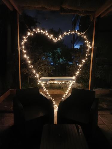a heart with lights in a window at night at Casa Vacanza Ottavia Roma in Rome