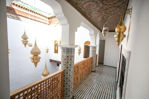 a hallway of a house with a tile floor at Riad Old City Palace in Fès