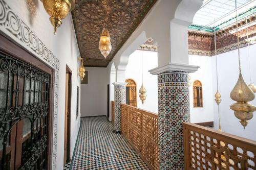 a hallway of a house with a tile floor and a ceiling at Riad Old City Palace in Fès