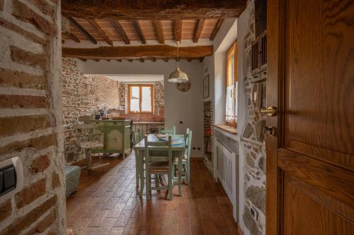 a kitchen with a table and a dining room at Consi's House - ItalyWeGo in Torgiano